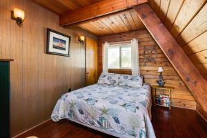 a bedroom with a bed in a wooden cabin at Pirate's Paradise in Lincoln City