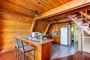 a kitchen with a counter with a stove and a refrigerator at Pirate's Paradise in Lincoln City