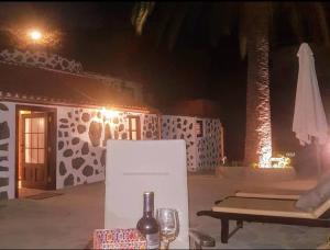 a table with a sign and a bottle of wine at Casa Rural LAS TIAS II in Tijarafe +25 photos