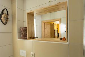 a mirror on a wall in a bathroom at Hügelhus in Kloster