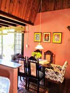 a dining room with a table and chairs at Casa na Praia do Rosa in Praia do Rosa