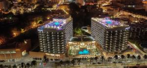 an aerial view of two tall buildings at night at Melia Costa del Sol in Torremolinos