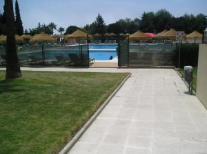 a swimming pool with umbrellas and a swimming pool at Studio in Hercules with pool and sea view in Benalmádena +7 photos