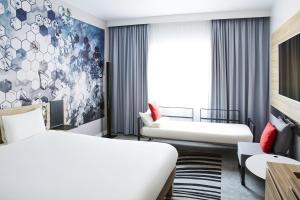 A bed or beds in a room at Novotel Manchester Centre