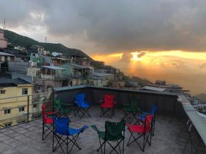 a group of chairs sitting on top of a roof at 九窩Jiu Wow Box Inn Jiufen九份 in Jiufen