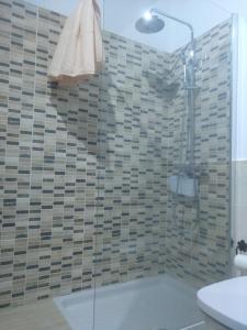 a bathroom with a shower with a glass door at Casa la plaza in Agulo +67 photos