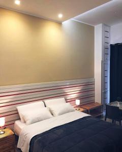 a bedroom with a large bed with a striped wall at La Stella Di Napoli B&B in Naples