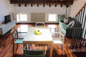 a living room with a table with a bowl of fruit on it at Sant'Agata in Ravenna