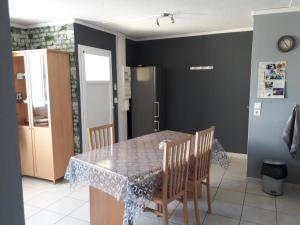 a kitchen with a table and chairs and a refrigerator at Maison Tifaloc in Montélimar