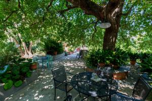 梅塔的住宿－Villa la Quercia，树下带桌椅的天井