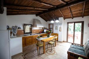 a kitchen with wooden cabinets and a wooden table at Casavacanzeinsicilia Etna Taormina in Piedimonte Etneo
