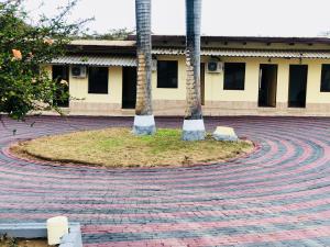 two palm trees in the middle of a brick road at Maite Villa Lodge in Thohoyandou