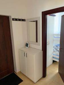 a room with a white cabinet and a mirror at Tamaris House Apartment 16 in Herceg-Novi