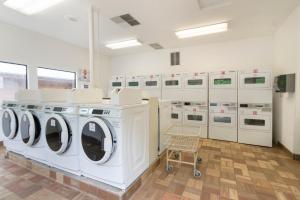 a laundry room with a row of washers and dryers at Mount Hood Village Deluxe Cabin 5 in Welches