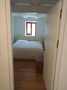 a small bedroom with a bed and a window at Wälderhus Tamegger in Krumbach