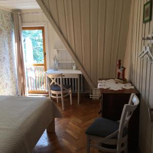 a bedroom with a bed and a table and chairs at Leśny Ogród in Lanckorona