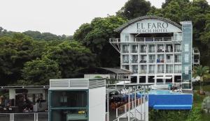 a clock tower in the middle of a city at El Faro Beach Hotel in Manuel Antonio