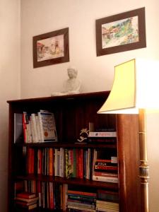 a book shelf filled with books next to a lamp at Leśny Ogród in Lanckorona