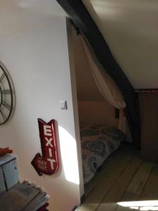 a small room with a bed in a attic at Le Grenier in Les Ageux