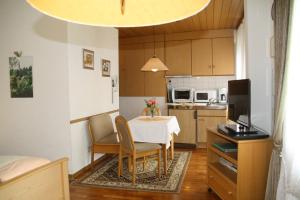 a kitchen with a table and chairs in a room at Gästehaus Kirchlay in Kröv