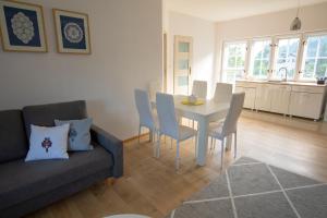 a living room with a couch and a table and chairs at Józefina in Szczyrk