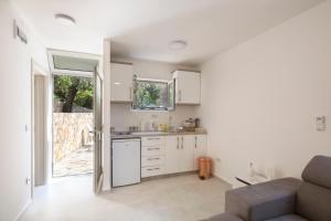 a kitchen and living room with a couch and a window at Luna apartment in Petrovac na Moru