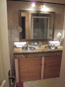 a bathroom with two sinks and a large mirror at Chateau Du Comte in Saint-Nazaire-dʼAude