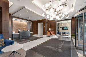 a living room with a large chandelier at Global Luxury Suites Downtown Jersey City in Jersey City