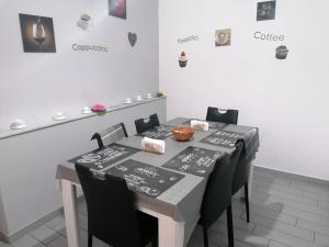 a table with black and white table cloths on it at Casa Normanna in Monreale