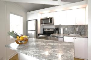 a kitchen with a bowl of fruit on a counter at Topsider Resort by Capital Vacations in Lower Matecumbe Beach