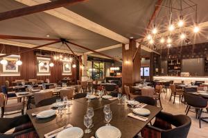 a restaurant with tables and chairs and lights at Hotel Pela in Ohrid