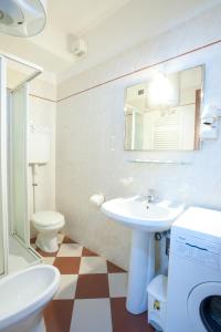 a bathroom with a sink and a toilet and a mirror at Giada in Moneglia