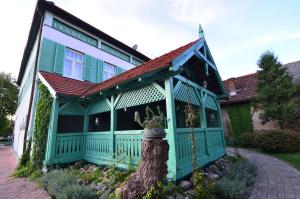 a green house with a tree in front of it at Baronka Bed & Breakfast & Bistrot in Betliar