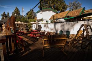 a group of chairs sitting on a wooden deck at Embers Lodge & Cabins in Big Bear Lake