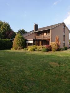 a large house with a lawn in front of it at Domizil & Dümmer in Lembruch