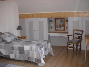 a bedroom with a bed and a desk and a chair at LA CONTAMINE in Nâves-Parmelan