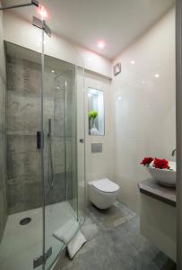 a bathroom with a shower and a toilet and a sink at STOP Apartment in Suwałki