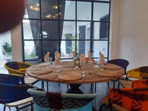 a table in a room with a large window at Siki Hotel in Saint-Louis