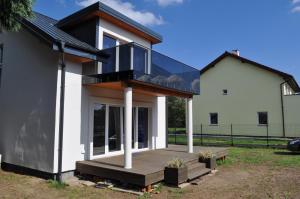a house with a glass roof and a deck at Villa Helena in Nowe Warpno
