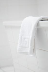 a towel hanging on a towel rack in a bathroom at Apartmenthaus Feuerbach in Leipzig