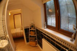 a room with a staircase with a mirror and a bedroom at Hooters Apartment EV Point in Wadebridge