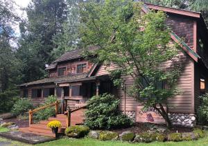 a small house with a wooden porch and a deck at Stormking Hotel in Ashford