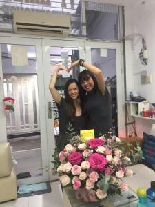 two women posing in front of a mirror with flowers at Vy Khanh Guesthouse in Ho Chi Minh City