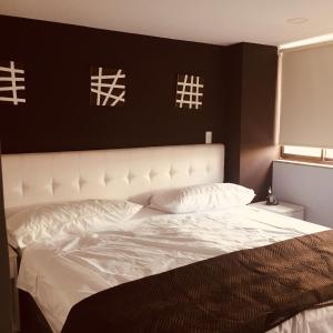 Postel nebo postele na pokoji v ubytování Hotel Garden City Boutique