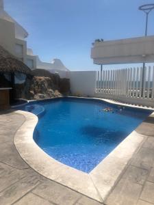 a swimming pool in the middle of a building at Hotel Playa María in Mazatlán