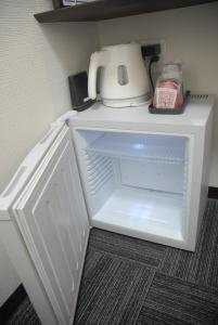 an open refrigerator with a blender on top of it at Okachimachi Urban Hotel in Tokyo