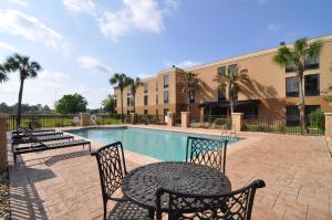 a patio with a table and chairs next to a pool at Best Western Plus Madison in Madison