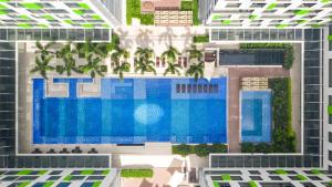 an aerial view of a building with a swimming pool at Holiday Inn & Suites Saigon Airport by IHG in Ho Chi Minh City