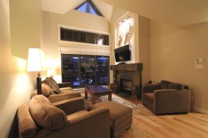a living room with two couches and a fireplace at Villas Snowberry by Whistler Retreats in Whistler