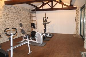 a gym with several exercise equipment in a room at GUTKOWSKI Jacqueline in Saint-Philbert-de-Bouaine